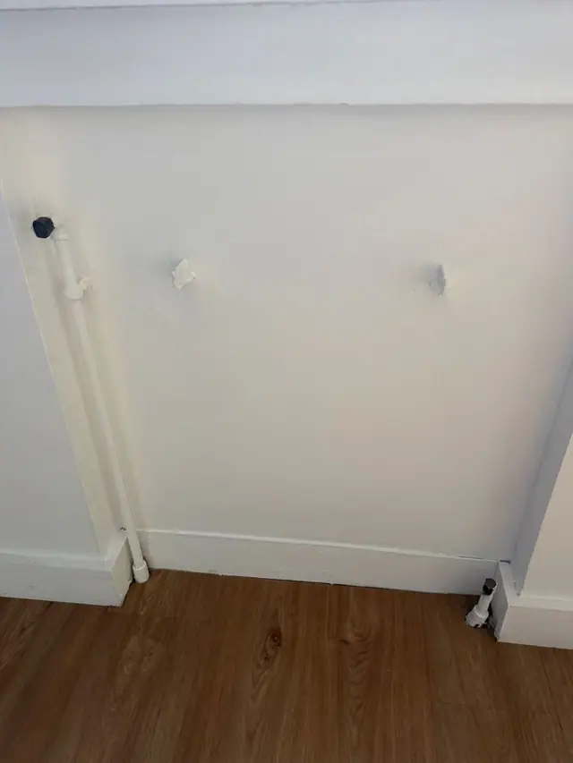 Chambre après : mur et plinthe repeints en blanc derrière l'emplacement du radiateur.